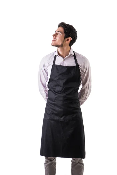 Young chef or waiter wearing black apron isolated — Stock Photo, Image