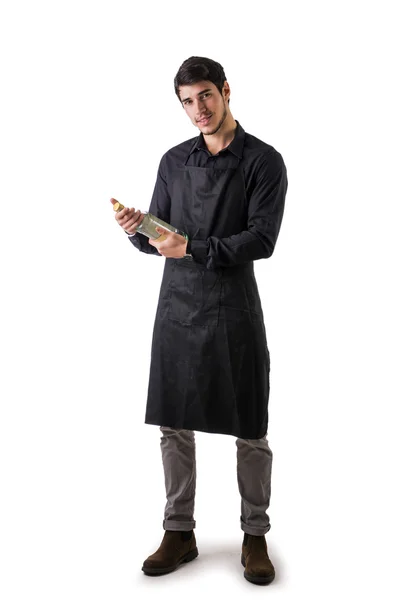 Young chef or waiter wearing black apron isolated — Stock Photo, Image