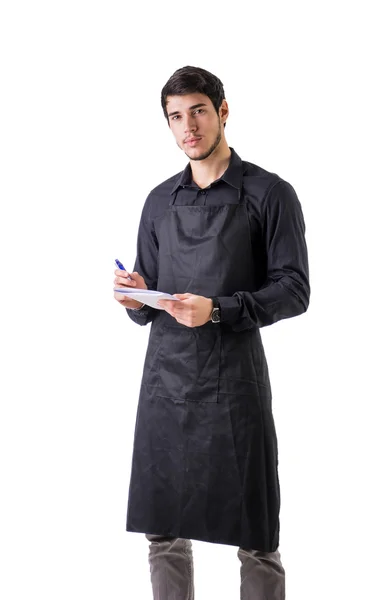 Молодий шеф-кухар або офіціант в чорному фартуху ізольовані — стокове фото