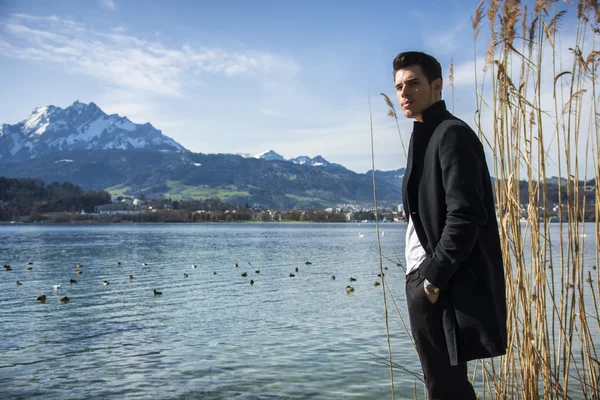 Handsome young man on Luzern lakes shore — Stock Photo, Image