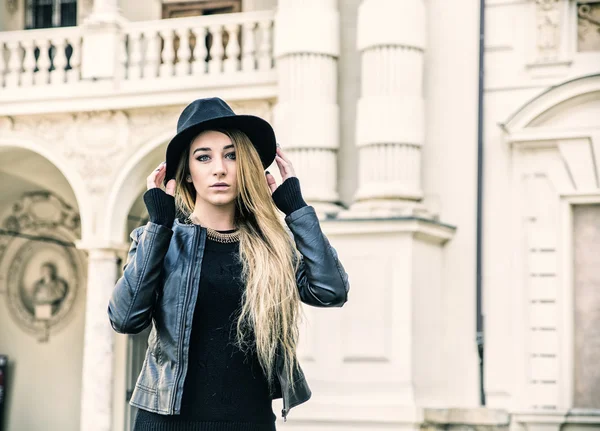 Beautiful young woman in black hat — Stock Photo, Image