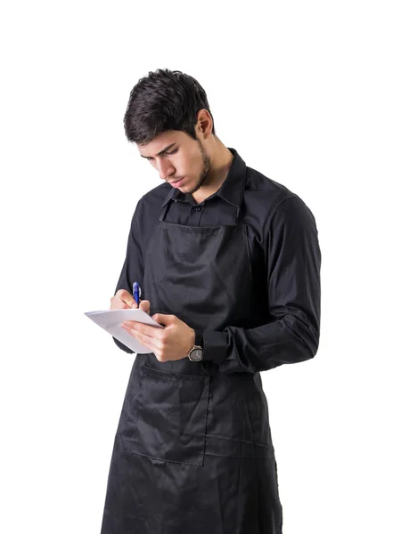 Young chef or waiter wearing black apron isolated — Stock Photo, Image