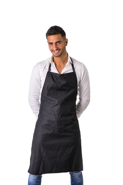 Young chef or waiter wearing black apron isolated — Stock Photo, Image