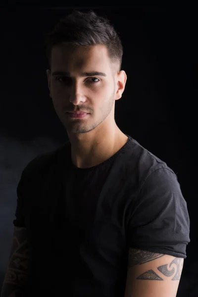 Young man with black t-shirt and tattoos — Stock Photo, Image