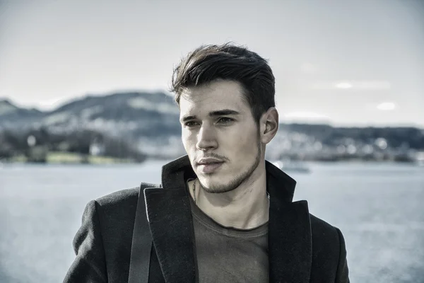Handsome young man on Luzern lakes shore — Stock Photo, Image