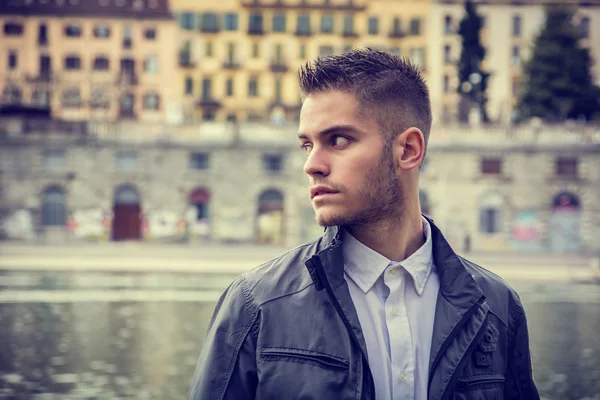 Contemplative young man standing beside river — Stock Photo, Image