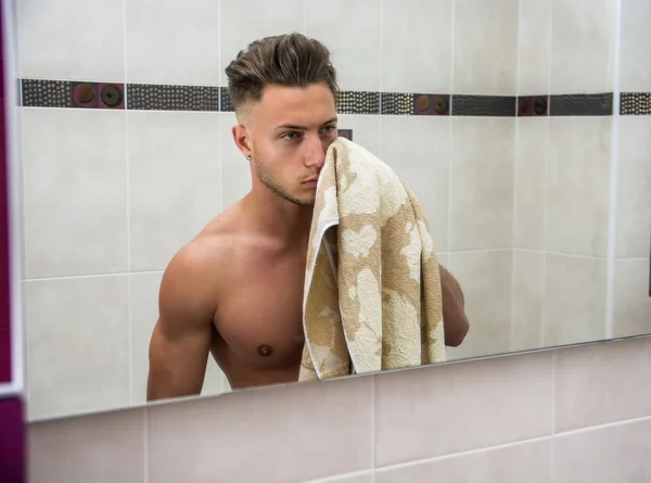 Shirtless muscular handsome young man in bathroom — Stock Photo, Image