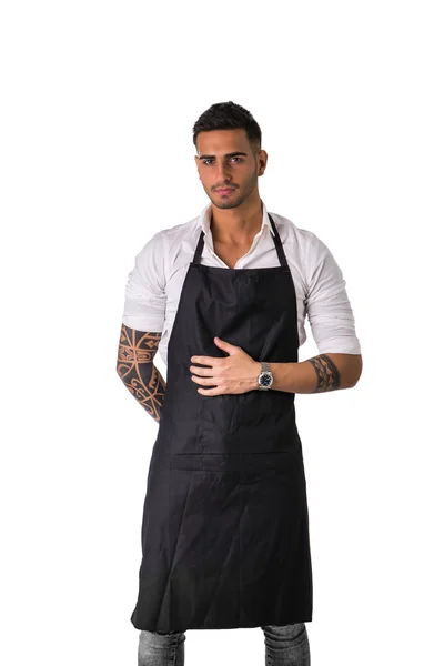 Young chef or waiter wearing black apron isolated — Stock Photo, Image