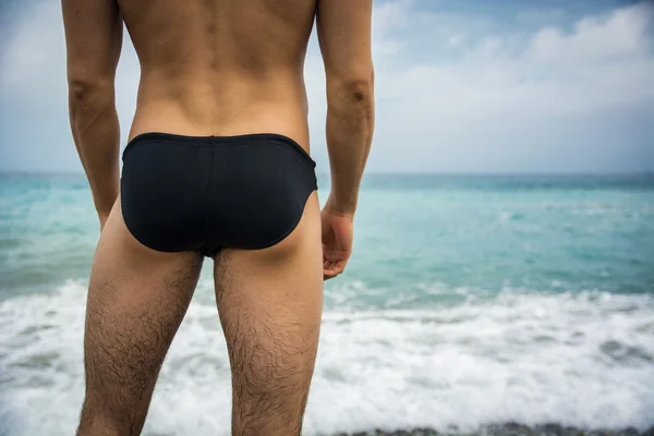 Back view of man in trunks against of seascape — Stock Photo, Image