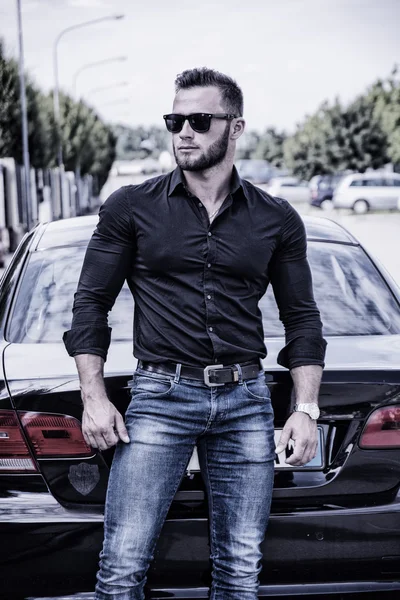 Handsome bearded man next to car in sunglasses — Stock Photo, Image