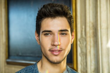 Yüzünde gökkuşağı olan genç bir adam