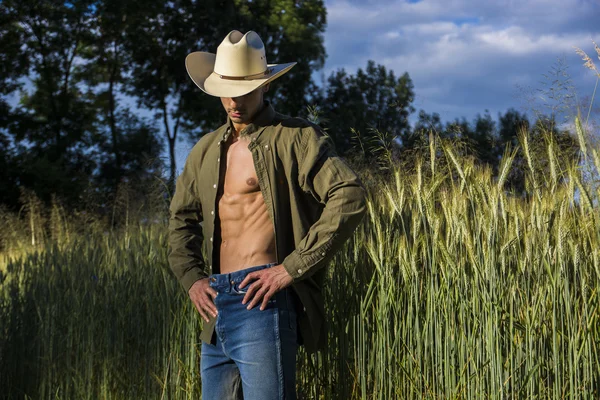 Retrato de homem rústico com chapéu de cowboy com camisa desabotoada — Fotografia de Stock