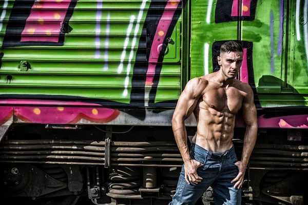 Sexy topless man posing against of train — Stock Photo, Image