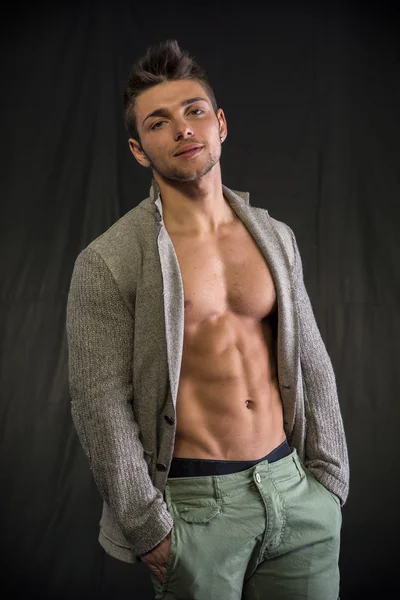 Young man with open jacket on muscular torso — Stock Photo, Image