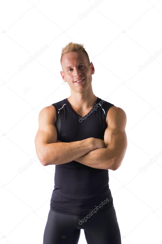 Fit male model smiling with a lot of confidence, arms crossed