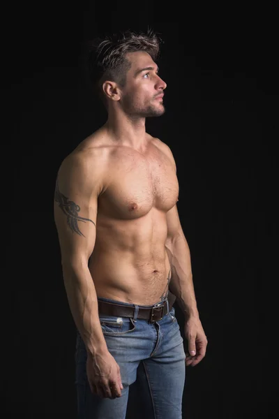 Handsome shirtless muscular man on black — Stock Photo, Image