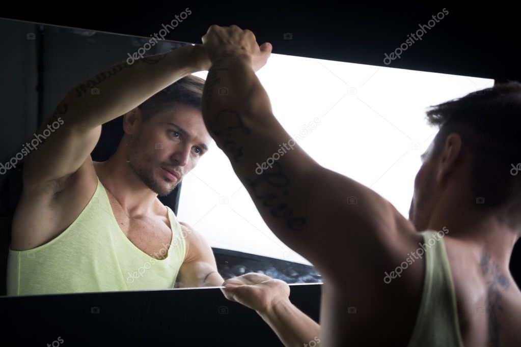 Narcissistic young man admiring his reflection