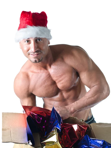 Christmas season: muscular bodybuilder in Santa Claus hat — Stock Photo, Image