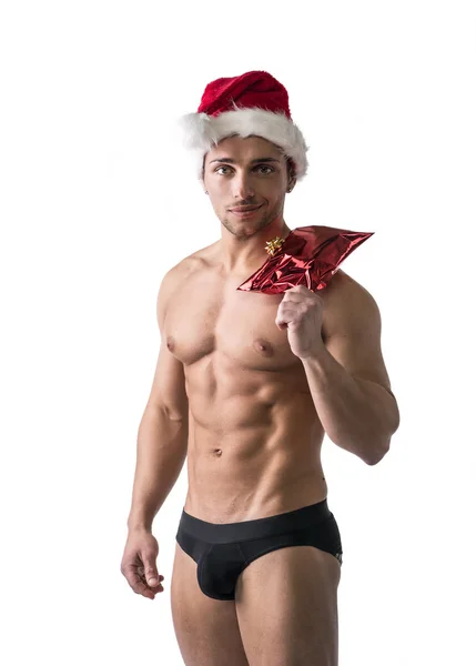 Christmas season: muscular bodybuilder in Santa Claus hat — Stock Photo, Image