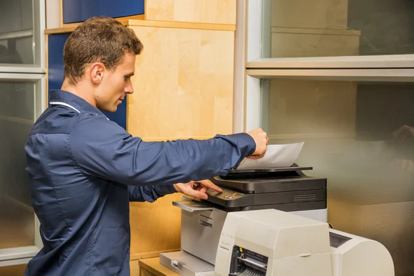 Young Man Operating Photocopier Machine — Stock Photo, Image