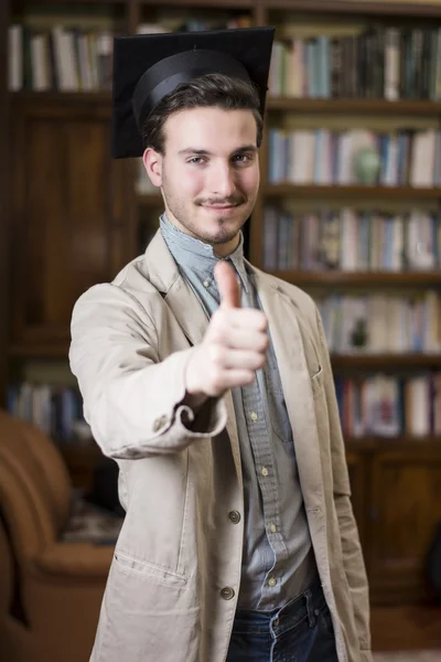 Happy young man graduating from college, with graduation hat — Stock Photo, Image