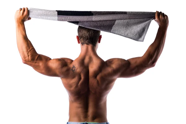 Back of shirtless muscular hunk holding towel above his head — Stock Photo, Image