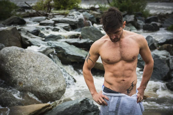 Handsome muscular young man outdoor wearing only towel — Stock Photo, Image