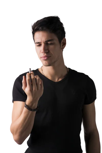 Young man disgusted by cigarette he's holding in his hand — Stock Photo, Image