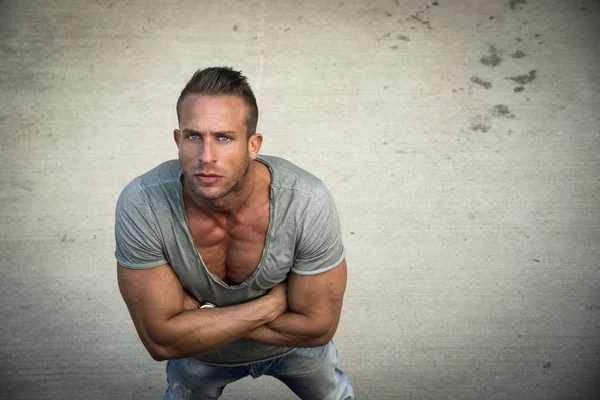 Handsome blond muscular man shot from above, looking up — Stock Photo, Image