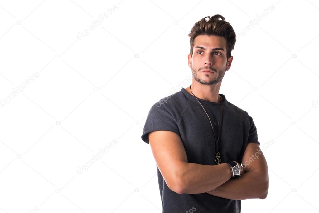 Fit handsome young man confident with arms crossed, looking up