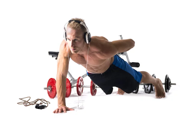 Muscular shirtless young man exercising with weights isolated — Stock Photo, Image