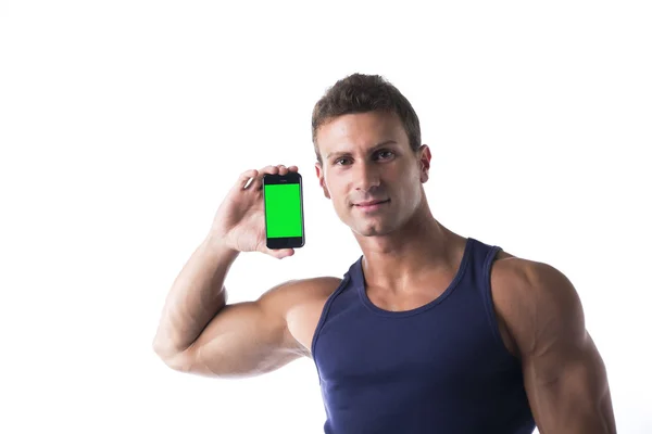 Hombre joven atractivo mostrando pantalla verde en blanco de su teléfono celular —  Fotos de Stock
