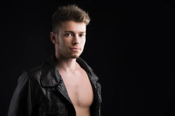 Attractive young man with leather jacket on naked torso — Stock Photo, Image