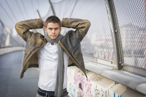 Handsome trendy man standing on a sidewalk — Stock Photo, Image