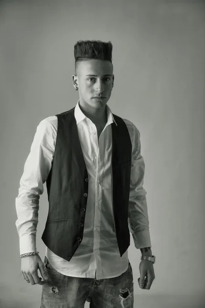 Trendy young man standing in studio — Stock Photo, Image