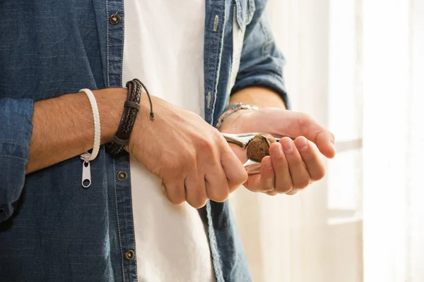 Hands of man cracking nut with nutcracker — Stock Photo, Image