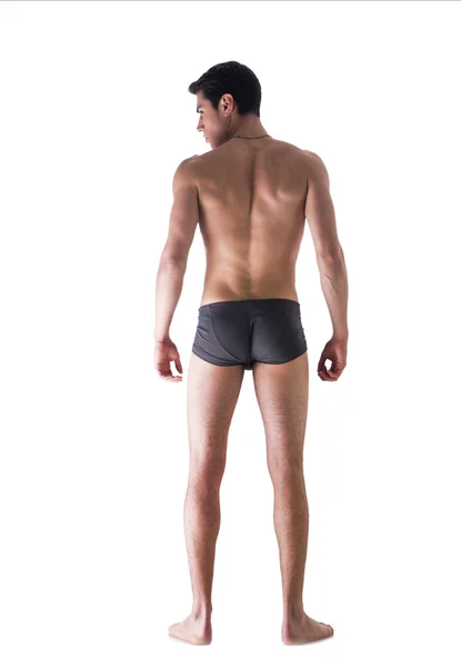 Ganzkörper motiviert jungen Mannes gesehen von der Rückseite in Unterwäsche isola — Stockfoto