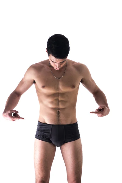 Young man in underwear pointing fingers at empty blank space for copy — Stock Photo, Image