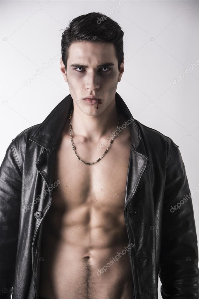 Young Vampire Man in an Open Black Leather Jacket, Showing his Chest and Abs