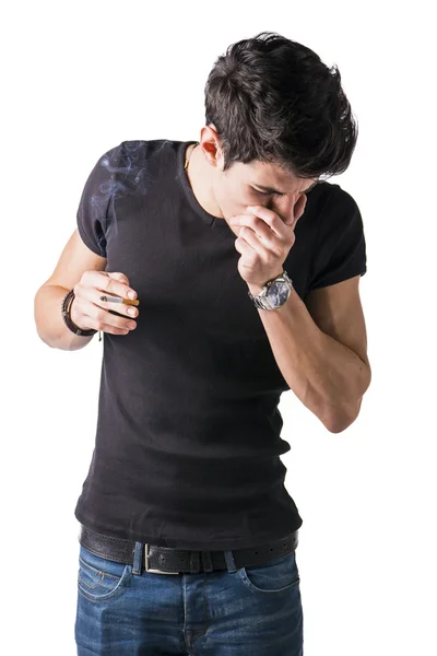 Handsome man holding a cigarette, coughing — Stock Photo, Image