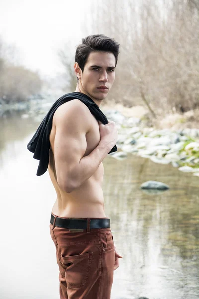 Young man outdoor at river or water stream — Stock Photo, Image