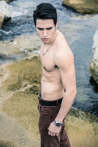 Shirtless young man outdoor at river or water stream — Stock Photo, Image