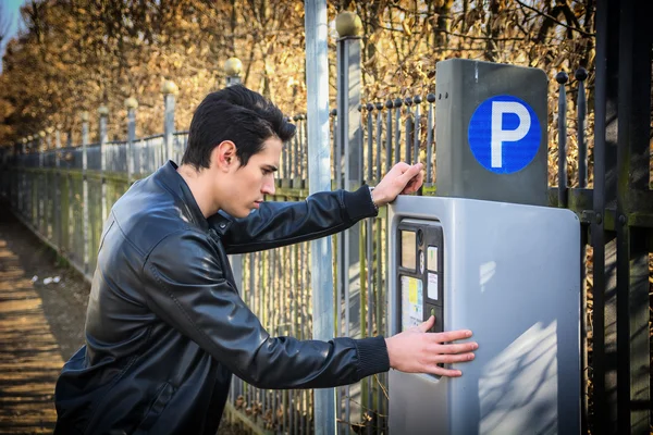 Young man waiting for a parking ticket — Stock Photo, Image
