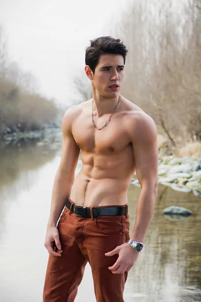 Shirtless young man outdoor at river or water stream — Stock Photo, Image