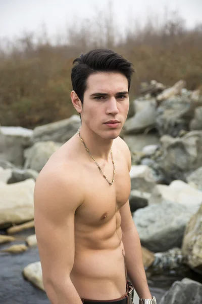 Shirtless young man outdoor at river or water stream — Stock Photo, Image