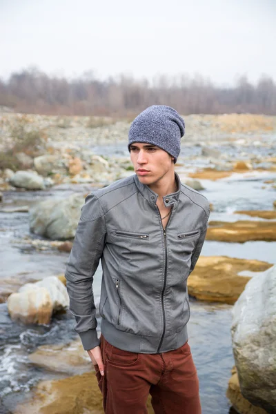 Young man outdoor in nature, at river or water stream — Stock Photo, Image