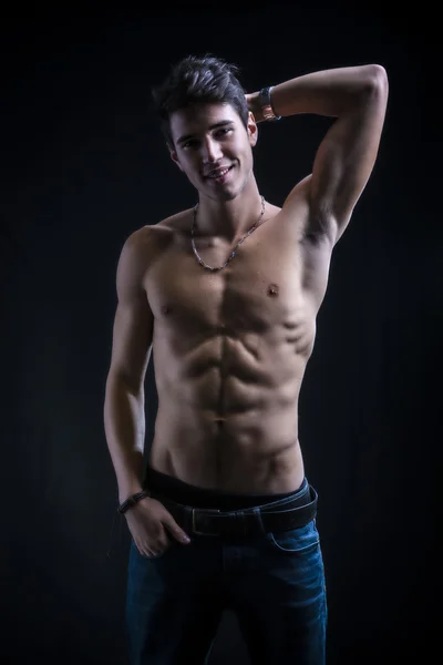 Handsome muscular shirtless young man standing — Stock Photo, Image