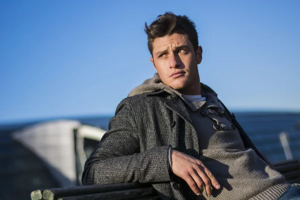 Handsome young man in city setting, lit by sunset light — Stock Photo, Image