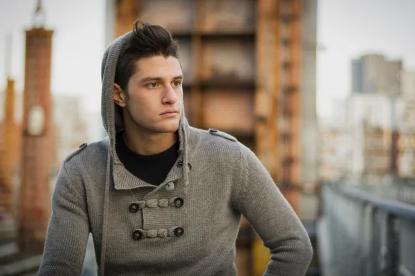 Handsome young man in city setting, industrial site — Stock Photo, Image