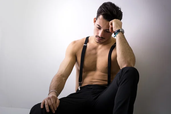 Shirtless athletic young man with suspenders — Stock Photo, Image